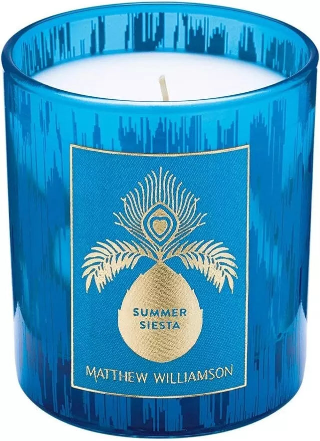 Blue glass candle jar with elegant pineapple and peacock design by Matthew Williamson.