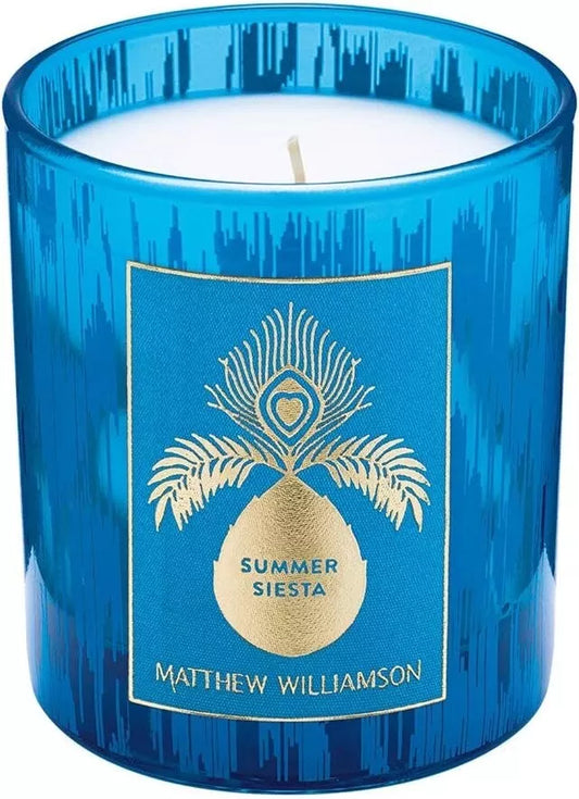 Blue glass candle jar with elegant pineapple and peacock design by Matthew Williamson.