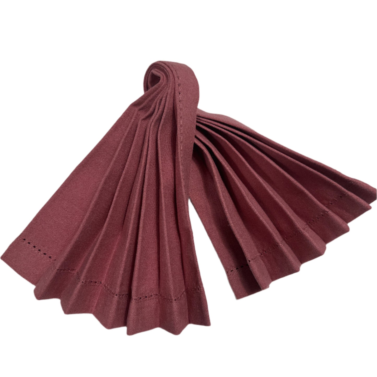 Close-up image of burgundy cotton napkin, folded into pleats with a stitched edge, showcasing a neat and elegant design