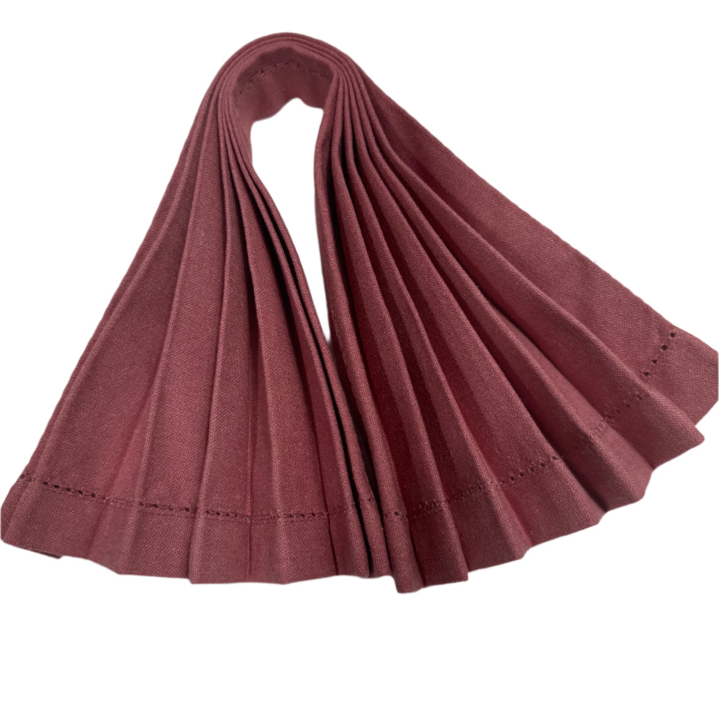 Fan-folded cotton napkin in a rich burgundy color, showcasing neat pleats and delicate stitching along the edges
