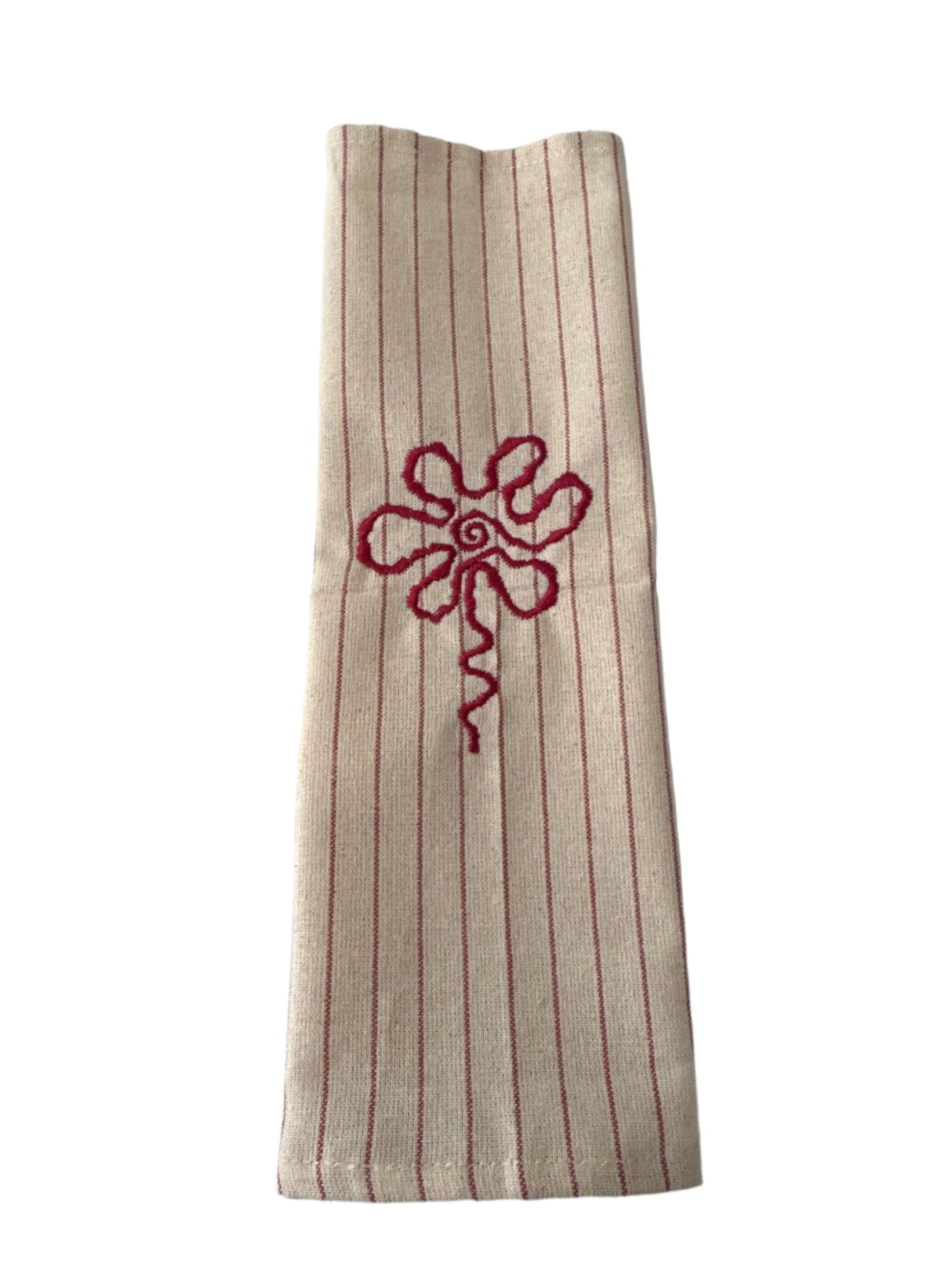 Unbleached cotton cloth napkin with red embroidered floral detail and subtle stripe pattern, 12 x 12 inch reusable eco friendly table napkin displayed folded on a neutral surface