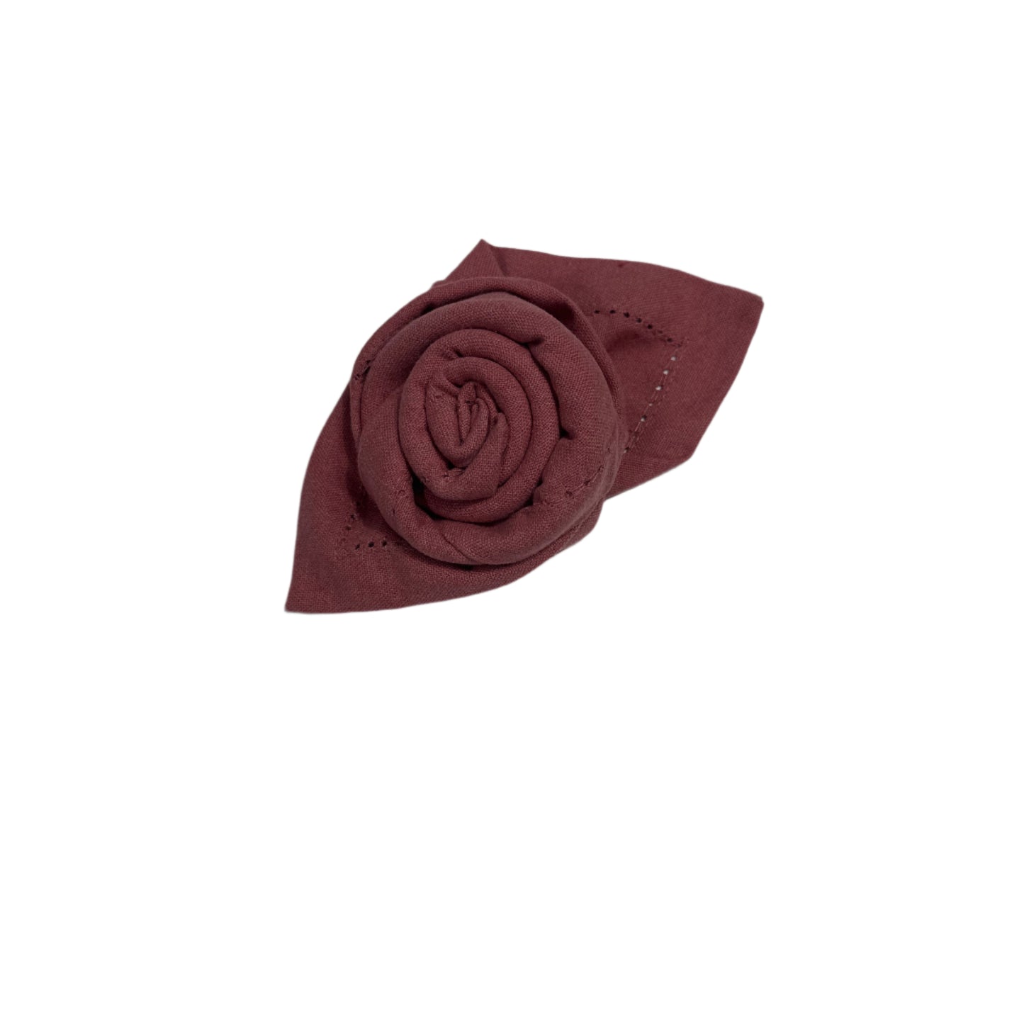Close-up of a beautifully folded cotton napkin shaped like a rose, showcasing fine stitching and a soft burgundy color with a decorative leaf design