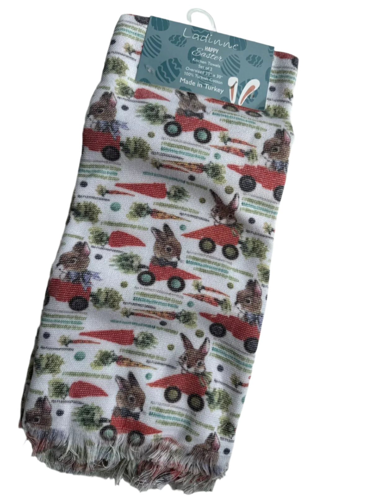 Pair of Easter-themed oversized kitchen towels with bunny and red truck design on white background.